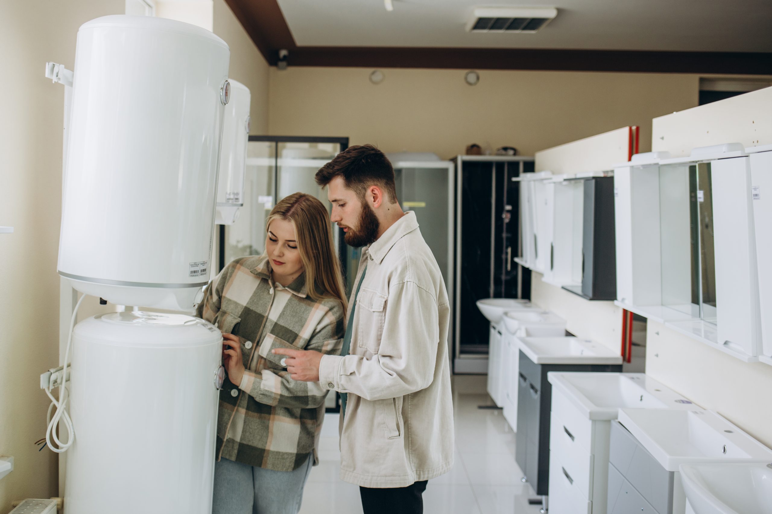 Happy young man and woman buying new heating water boiler